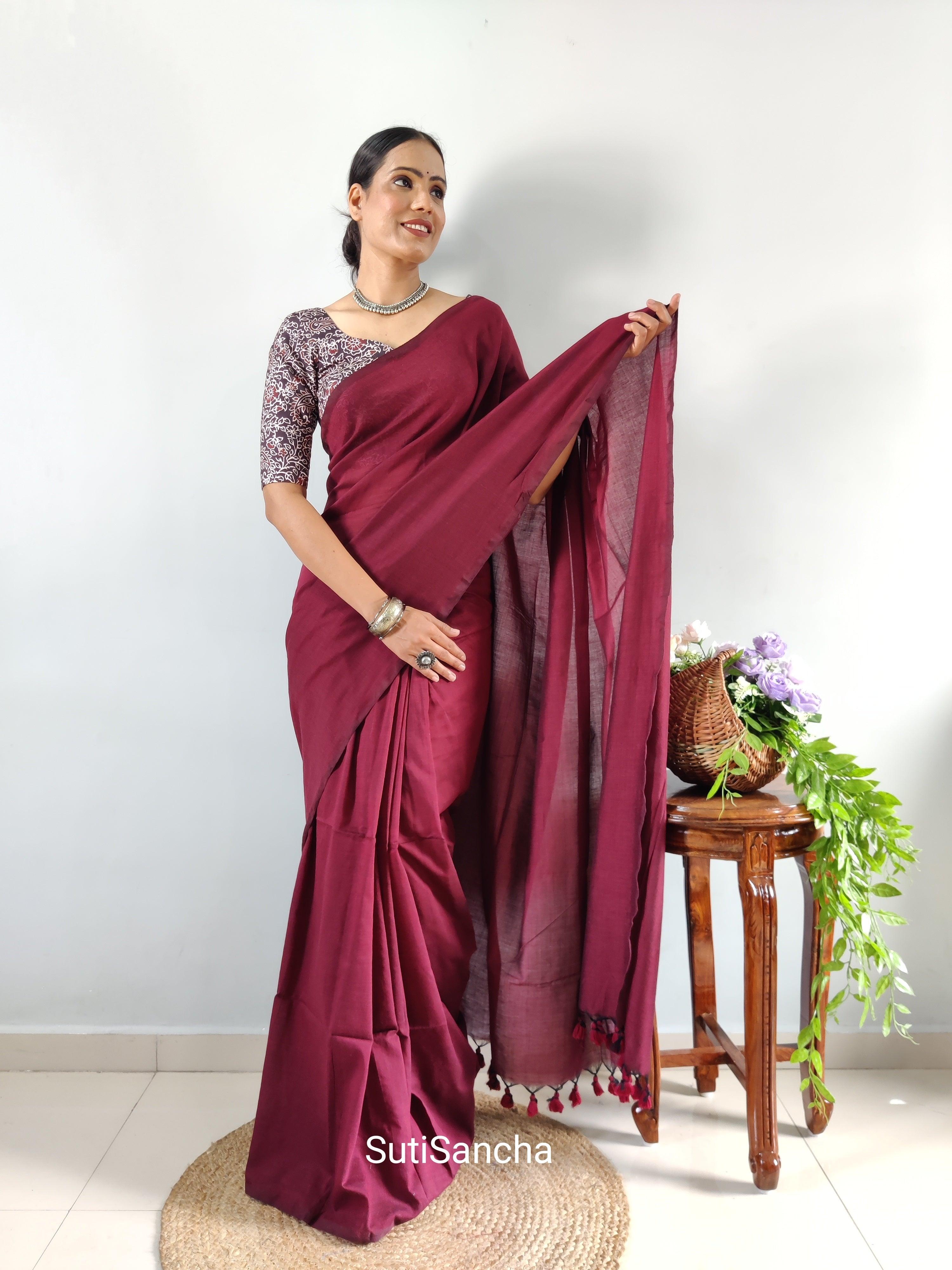 In a cream color ruffle saree and maroon color full sleeve blouse design